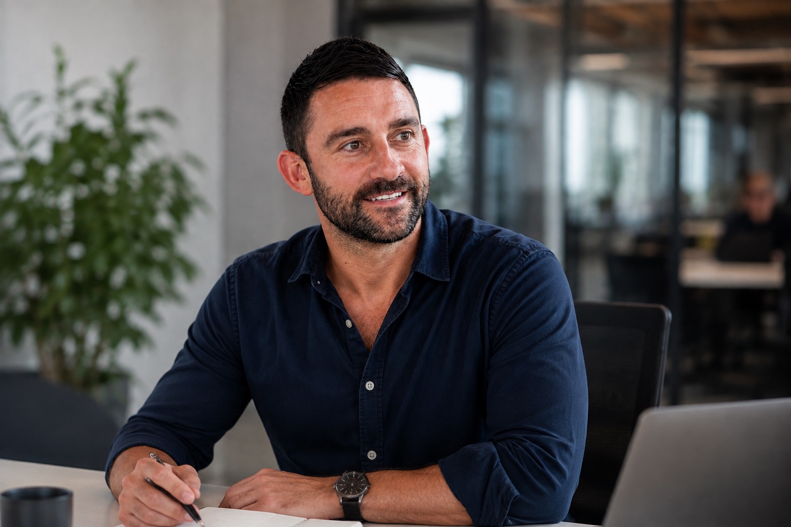 Jason Johnson making notes during a client review at his desk